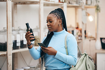 Image showing Woman, shopping and phone for ingredient reading in grocery store for healthy food, nutrition and product information. Research, confused and African customer with technology for supermarket choice