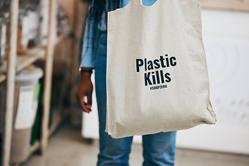 Image showing Person in eco friendly grocery store, recycling shopping bag and commitment to climate change at sustainable small business. Zero waste, plastic kills logo and supermarket carbon footprint choice.