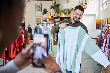 Image showing Man, shopping and clothes with photography, phone and happy for check, quality assurance or discount in mall. Designer, smartphone and fashion in boutique with promotion, deal or post on social media