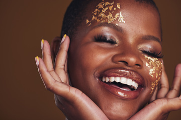 Image showing Gold, laughing and woman face closeup with makeup and luxury treatment with rich spa mask. Glitter, golden dermatology and African person happy from creative skincare and art cosmetics in studio