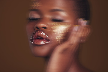 Image showing Gold beauty, makeup and woman skincare with blur in studio with glitter cosmetics and sparkle art. Brown background, African female model and shine from paint and glow with golden luxury treatment