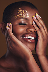 Image showing Art, cosmetics and black woman with gold makeup on brown background, glitter paint and beauty. Shine, glow and African model in studio for fashion inspiration, aesthetic freedom and luxury skincare.