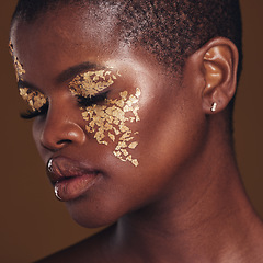 Image showing Gold, art and face of black woman with makeup for beauty aesthetics isolated in a studio brown background eyes closed. Creative, luxury and African person with cosmetic glamour or design for skincare