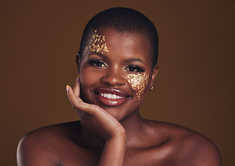 Image showing Gold, glitter portrait and black woman beauty with makeup and skincare mask in studio with sparkle cosmetics. Brown background, funny and model with golden paint for skin glow and creative shine