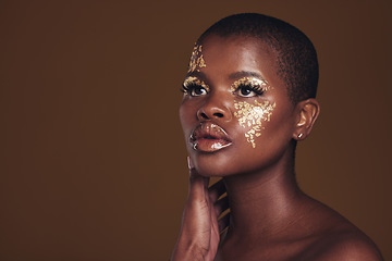 Image showing Art, mockup and black woman with gold makeup on brown background, glitter paint and cosmetics. Shine, glow and African model in studio for beauty, fashion and aesthetic freedom in luxury skincare.