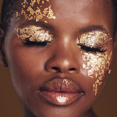 Image showing Gold, art and black woman with makeup for beauty aesthetics isolated in a studio brown background eyes closed. Creative, luxury and face of African person with cosmetic glamour or design for skincare