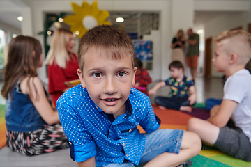 Image showing Portrait photo of a smiling boy in a preschool institution having fun