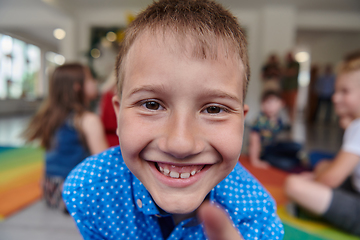 Image showing Portrait photo of a smiling boy in a preschool institution having fun
