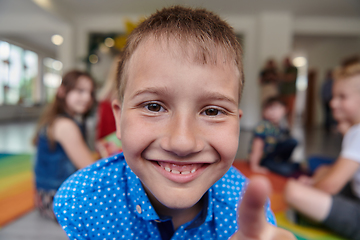 Image showing Portrait photo of a smiling boy in a preschool institution having fun