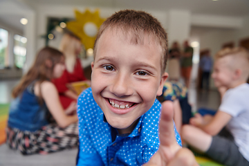 Image showing Portrait photo of a smiling boy in a preschool institution having fun