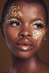 Image showing Art, face of black woman with gold makeup and brown background, glitter paint and cosmetics. Shine, glow and African model in studio on facial beauty, fashion and aesthetic freedom in luxury skincare