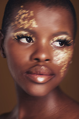 Image showing Gold, art and African woman with makeup for beauty aesthetics isolated in a studio brown background thinking. Creative, luxury and face of person with cosmetic glamour or design for skincare