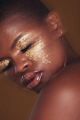 Image showing Gold beauty, blurred and black woman with eye makeup closeup with cosmetics in studio. Brown background, African female person and glitter with golden shine and glow from facial paint sparkle