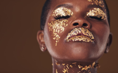 Image showing Gold, art and face of African woman with makeup for beauty aesthetics isolated in a studio brown background eyes closed. Creative, luxury and person with cosmetic glamour or design for skincare