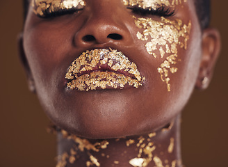 Image showing Gold, creative and face of black woman with makeup for beauty aesthetics isolated in a studio brown background eyes closed. Art, luxury and African person with cosmetic glamour or design for skincare