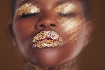 Image showing Gold beauty, face and woman closeup with blur in studio with glitter cosmetics and sparkle art. Brown background, African female model and shine from makeup and skin glow with golden luxury treatment