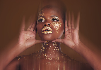 Image showing Gold beauty, makeup and black woman face with hands and blur in studio with glitter cosmetics and sparkle art. Brown background, African female model and shine from paint glow with luxury treatment