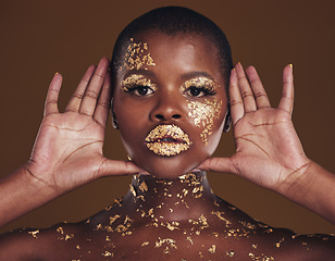 Image showing Cosmetics, portrait and black woman with gold makeup on brown background with glitter paint. Shine, glow and African model in studio for beauty, fashion art and aesthetic freedom in luxury skincare.