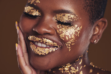 Image showing Black woman, face and gold makeup closeup with luxury dermatology and skincare mask with glitter. Sparkle, smile and beauty with rich and shine of cosmetics and model in a studio with facial art