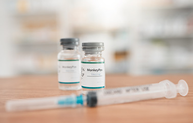 Image showing Pharmacy, syringe and medication for monkeypox vaccine, healthcare or vial in medical cure on table. Drugs, needle and pharmaceutical product on desk for vaccination, flu shot or equipment at clinic