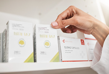 Image showing Person, pharmacist and hands with box on shelf for inventory inspection or checking stock at pharmacy. Closeup of medical or healthcare worker with pills, medication or pharmaceutical at drugstore