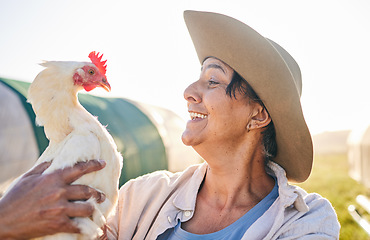 Image showing Agriculture, chicken and mature woman in farm, countryside and nature for small business growth. Environment, sustainable farming and happy farmer with bird for free range poultry production outdoors