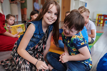 Image showing A girl and a boy with Down's syndrome in each other's arms spend time together in a preschool institution