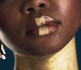 Image showing Closeup, lips and woman with makeup, creative and beauty on a dark studio background. Zoom, person and model with fine art, mouth and facial cosmetics with colorful skin art and aesthetic with gold