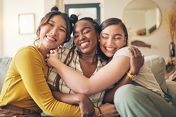 Image showing Portrait of a group of women, friends hug on sofa with smile and bonding in living room together in embrace. Hug, love and friendship, girls on couch with diversity, pride and people in home with fun