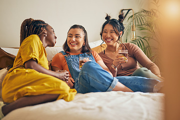 Image showing Friends, conversation and women with drink in home for relaxing, bonding and talking together. Friendship, happy and group of people laughing for relationship, visit and chat on sofa in living room