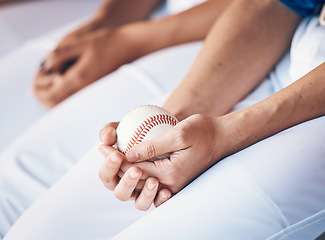 Image showing Hands, sports and baseball with a player in a dugout, waiting during a game of competition closeup. Ball, ready and uniform with an athlete holding equipment for a match in a stadium or venue