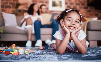 Image showing Child, toys and playing portrait in home with development and building block in living room. Family, youth smile and happy young girl with parents in a house together with care and kids learning