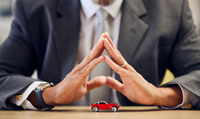 Image showing Desk, hands and a person covering for car insurance, investment and auto support. Table, corporate and a businessman with security or safety of transportation for a guarantee or premium service