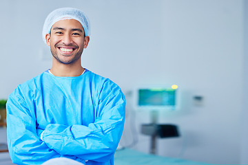 Image showing Portrait, surgeon and Asian man with arms crossed in hospital, healthcare and wellness. Face, happy doctor and medical professional, expert nurse and confident surgery employee in scrubs in Cambodia