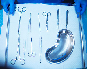 Image showing Surgery, tools and medical table in hospital, operation room and equipment with scalpel knife, scissors and metal bowl. Surgeon, hands and above doctor ready with medicine or tool for procedure