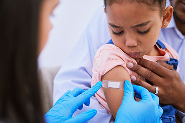 Image showing Doctor, dad and kid with plaster for vaccine, flu shot or medicine injection in clinic or hospital. Father, girl with bandage and pediatrician in office for vaccination, consultation and child care.