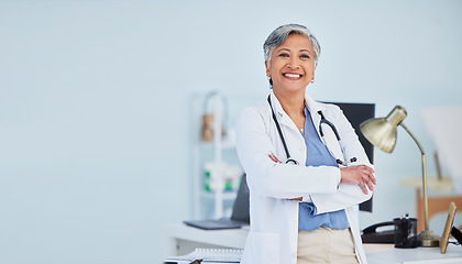 Image showing Arms crossed, doctor and space with portrait of woman in hospital for consulting, medical and pharmacy. Healthcare, medicine and happy with mature person in clinic for wellness, therapist and mockup