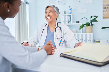 Image showing Happy doctor, patient and talking at consultation in hospital with a woman for medical advice. Health care worker and person for conversation, results and communication for wellness and health