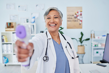 Image showing Happy mature woman, doctor and infrared thermometer in checking temperature or fever at hospital. Senior female person, medical or healthcare professional smile with laser scanner for flu screening