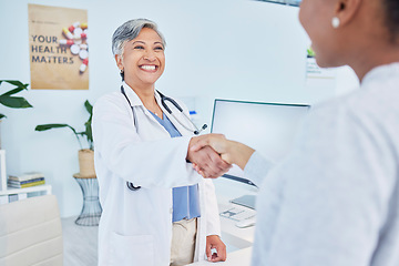 Image showing Happy doctor, handshake and meeting patient in healthcare, visit or appointment at the hospital. Mature female person or medical professional shaking hands with customer in greeting or consultation