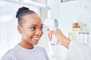 Image showing Black woman, doctor and infrared thermometer for temperature, fever or checkup at the hospital. Happy African female person or patient smile in screening, visit or regulation for health and safety