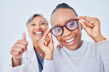 Image showing Eye care, glasses and patient with doctor, women at clinic, optometry and frame choice with help and thumbs up. Wellness, health and prescription lens, support from optometrist, trust and eyewear