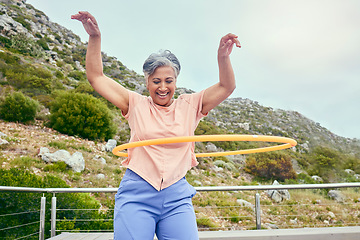 Image showing Senior woman, hoop and fitness outdoor with smile, training and playful on balcony, mountains and healthy. Mature lady, exercise and happy for wellness, stomach workout and toys on rooftop in Hawaii