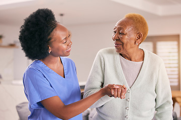 Image showing Help, nurse and holding hands of senior black woman, care and smile in house together. Caregiver, support and elderly patient with medical professional, kindness and happy in empathy for healthcare