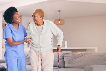 Image showing Nurse, holding hands and senior black woman with walking stick, help or smile in home. Caregiver, support and elderly patient with a disability, cane and kindness in assistance, empathy or healthcare