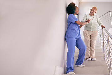 Image showing Nurse, stairs and help senior woman, holding hands and assistance in home. Caregiver, steps and elderly African patient walking down, support of person with a disability and happiness in healthcare