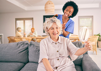 Image showing Nurse brush hair of happy mature woman in the living room of the modern retirement home for self care. Mirror, routine and African female nurse doing a hairstyle for an elderly patient in the lounge.