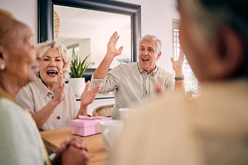 Image showing Senior friends, birthday celebration and party at a home with a present and gift with excited people. Surprise, singing and retirement of elderly group at a dining room table together with a smile