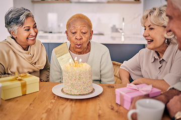 Image showing Senior women, friends and candles on birthday cake for a celebration, party and social gathering. Elderly people together at table to celebrate and blow flame at retirement home event with happiness