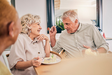 Image showing Food, retirement and a senior couple in an assisted living home while eating a meal for nutrition. Cute, love or smile with a happy elderly man feeding his wife in the dining room of a house